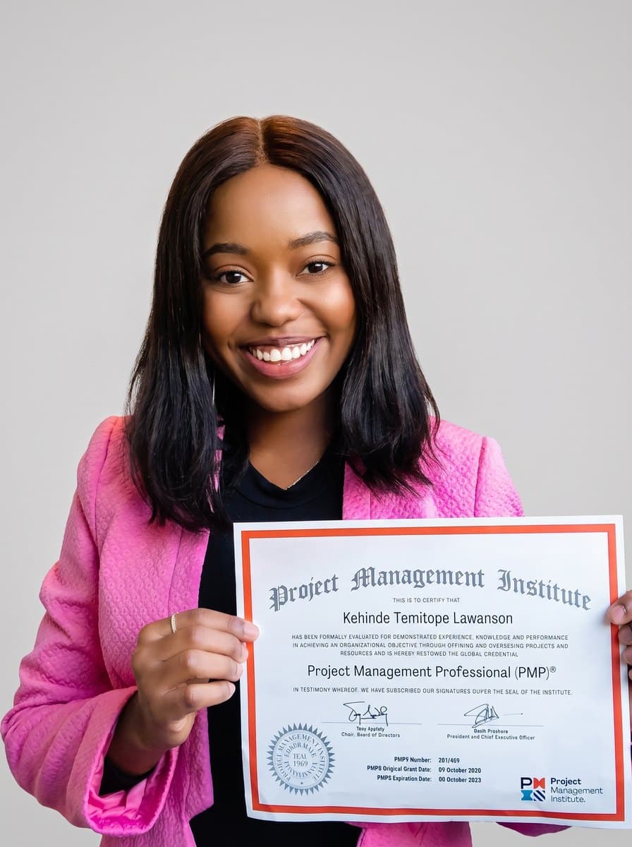 Kenny Lawanson holding a PMP certificate.
